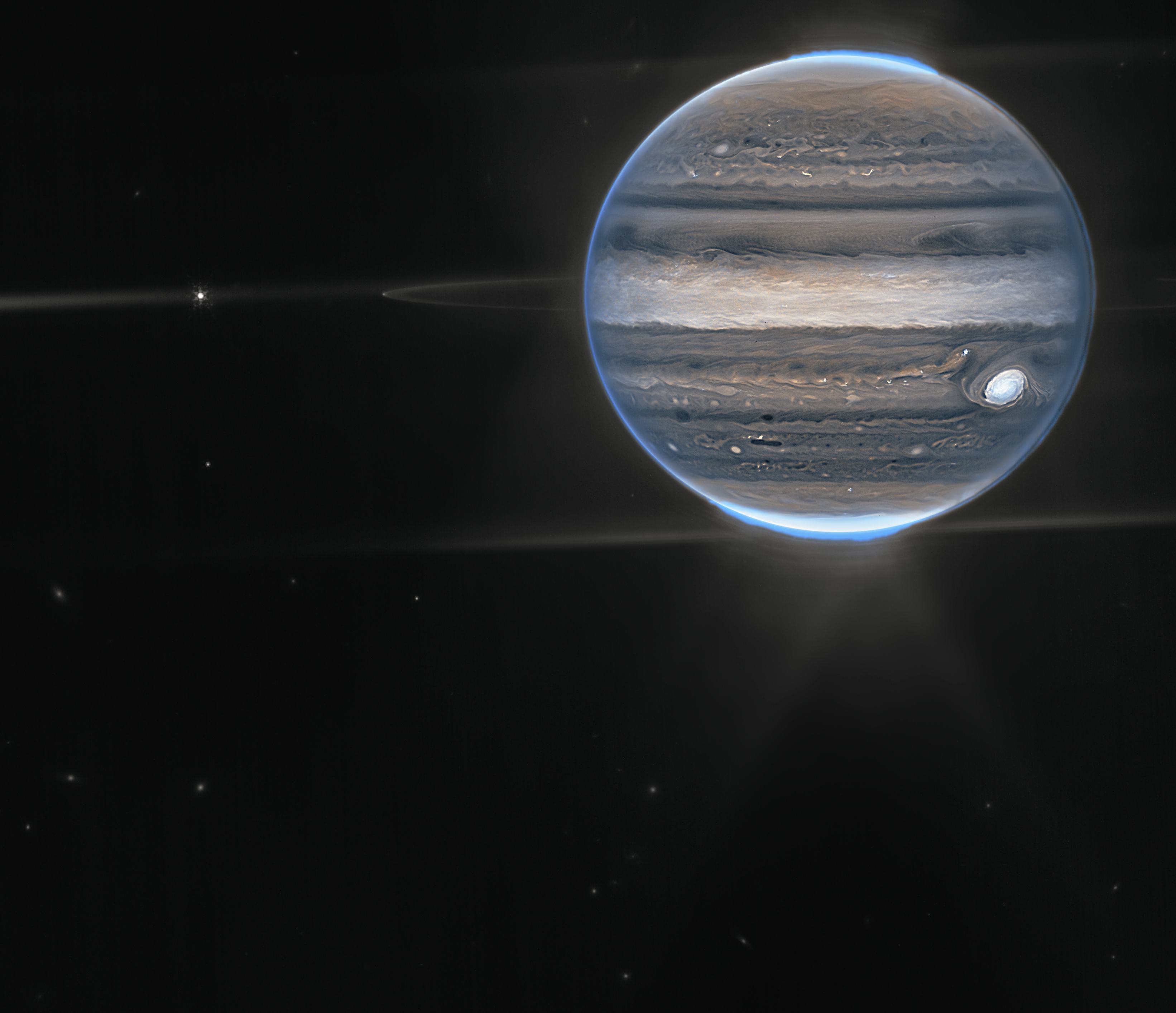 Webb NIRCam composite image from two filters – F212N (orange) and F335M (cyan) – of Jupiter system, ...