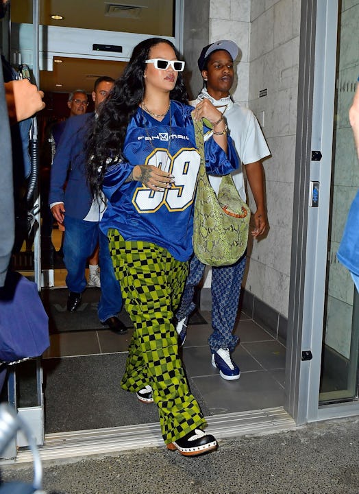 Rihanna and A$AP Rocky cut a stylish figure as they exit an office building in Manhattan and head ov...