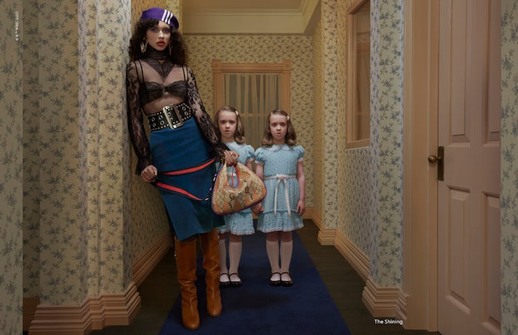 A model standing next to young twins in a Gucci campaign inspired by 'The Shining'