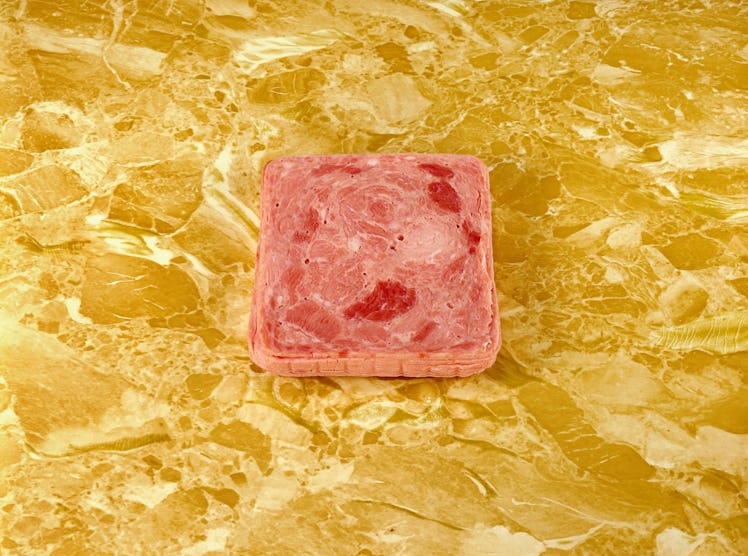 A Sandy Skoglund photograph of a luncheon meat on a gold counter