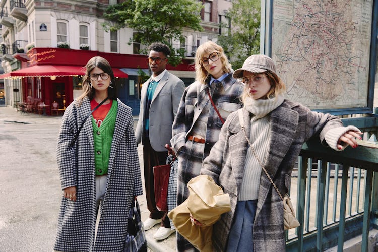 Four models standing on the street wearing checkered coats 