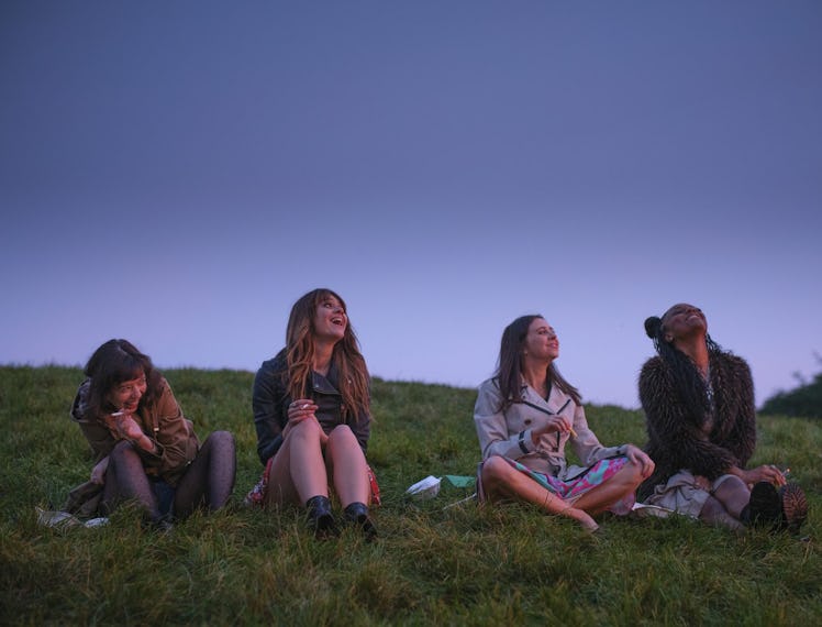 'Everything I Know About Love' cast sitting on grass.
