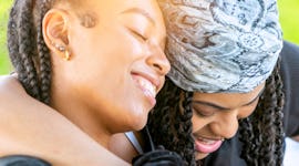 Young couple with their arms around each other on the most romantic day in September 2022 for every ...