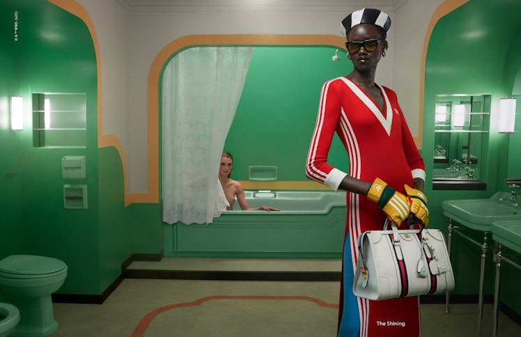 A model wearing a striped Gucci x Adidas dress in a Gucci campaign inspired by 'The Shining'