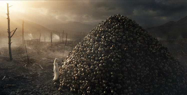 Galadriel (Morfydd Clark) stands in front of a pile of Elven helmets in The Lord of the Rings: The R...