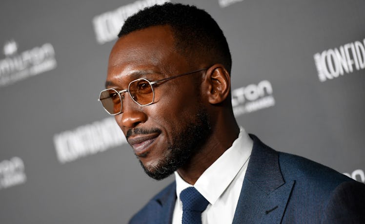 Mahershala Ali wearing tinted shades and a suit at a red carpet
