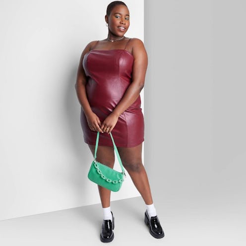 Woman wearing brown sleeveless faux leather bodycon dress from Target