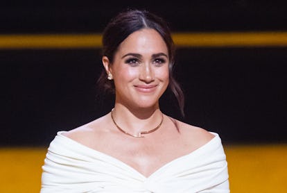 Meghan Markle looking off into the distance and smiling