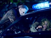 A scene from the movie 'Halloween' with Michael Myers attacking a woman in a car