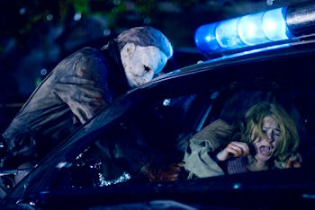 A scene from the movie 'Halloween' with Michael Myers attacking a woman in a car