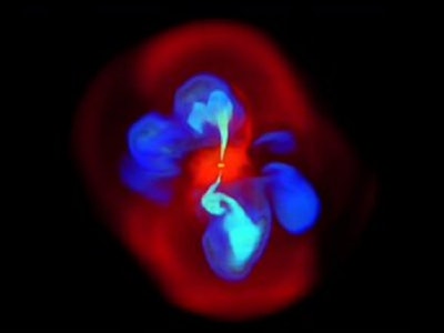 Image of a simulated supermassive black hole in reds and blues on a black background.