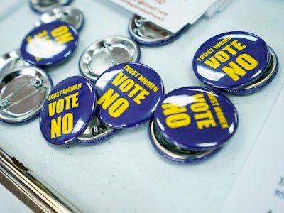 Badges for the Vote No on the Constitutional Amendment on Abortion are laid out for canvassers at th...