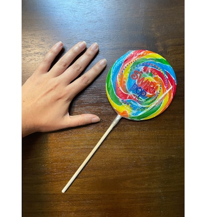 Lollipop against hand for scale.