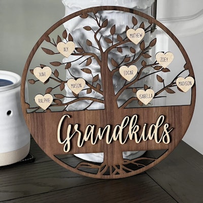 Wooden circular personalized grandkids family tree sign with kids' names in hearts, engraved for a g...