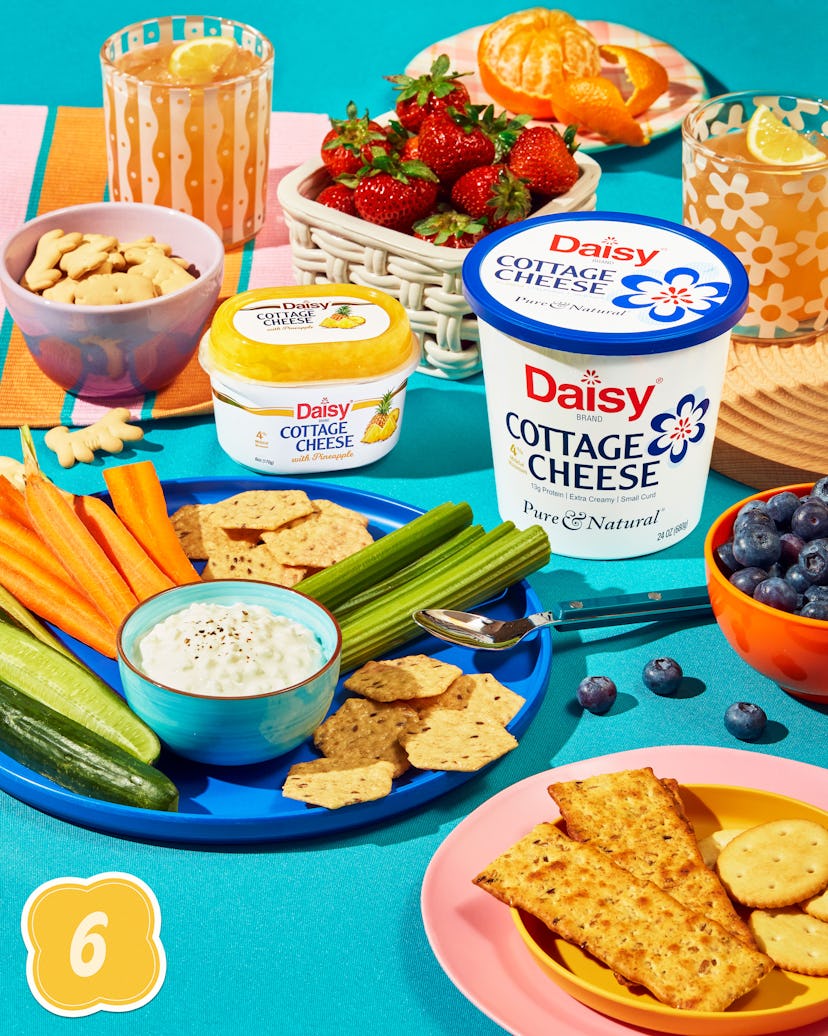 Daisy Cottage Cheese with pineapple and the original Daisy cottage cheese on a table surrounded by d...