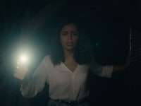 A woman in Barbarian walking in the dark and using her phone light 