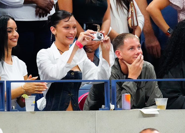 Bella Hadid holding a digital camera at Serena Williams's US Open match