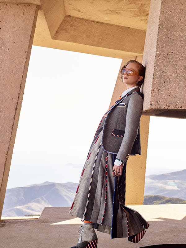 Hannah Einbinder in Thom Browne clothing, tie, socks, and shoes, Jennifer Fisher earrings, Burberry …