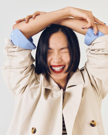 Happy woman with arms above her head.