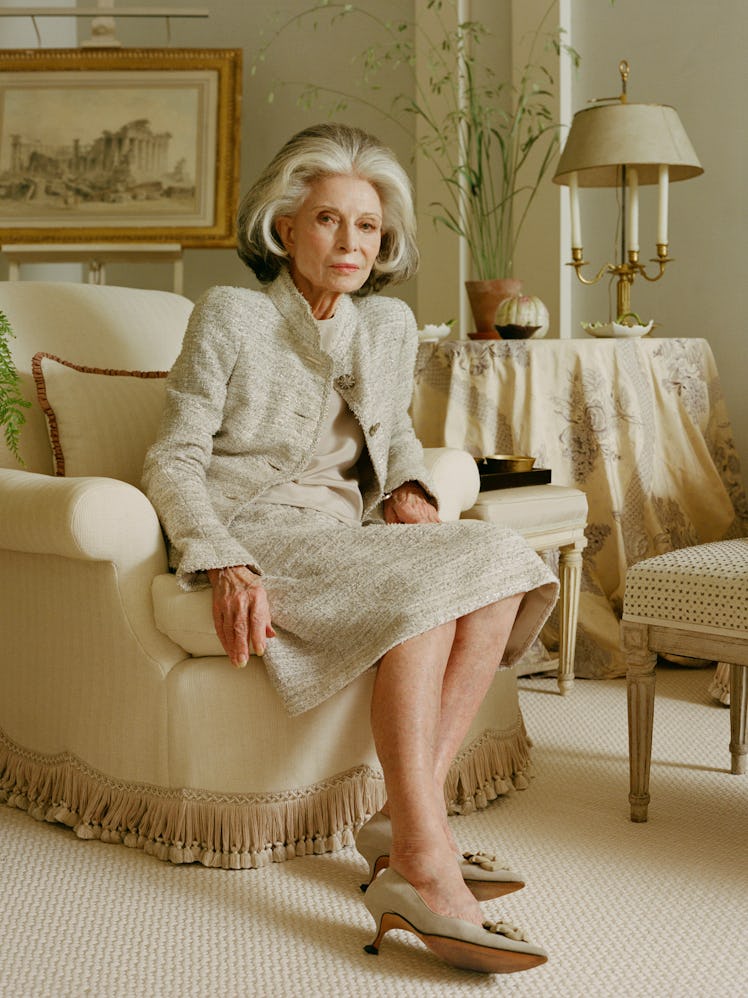 The elegant socialite Deeda Blair wearing a cream colored suit on a cream colored armchair in a crea...