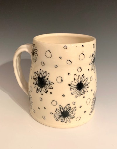 Cream colored hand-thrown mug with black hand-drawn daisies on it is a great grandparents day gift.