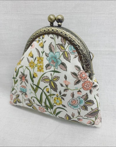 This change purse with a floral design on white fabric is the perfect grandparents day gift for gran...