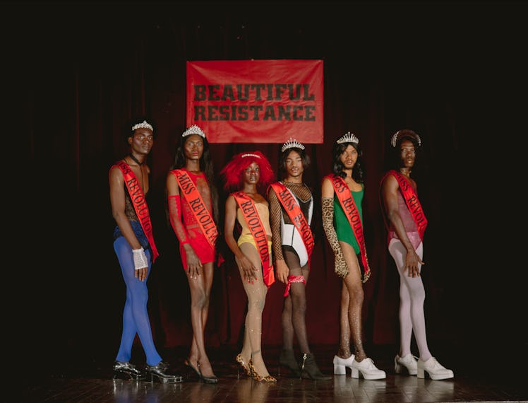 A photo of a group of pageant queens wearing 'Miss Revolution' sashes on stage.