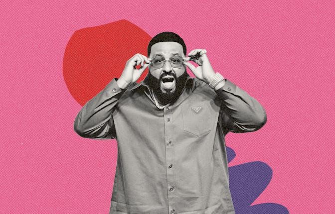 DJ Khaled posing, holding his sunglasses, in a button-up with a shocked facial expression