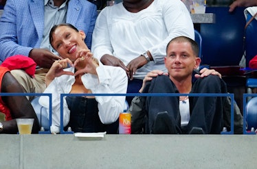 Bella Hadid making a heart sign at the U.S. Open with Marc Kalman