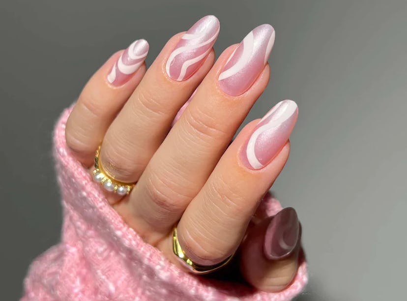 DIY Barbiecore swirl nails using ManiMe's Glazed Barbcore Era at-home gel manicure set.
