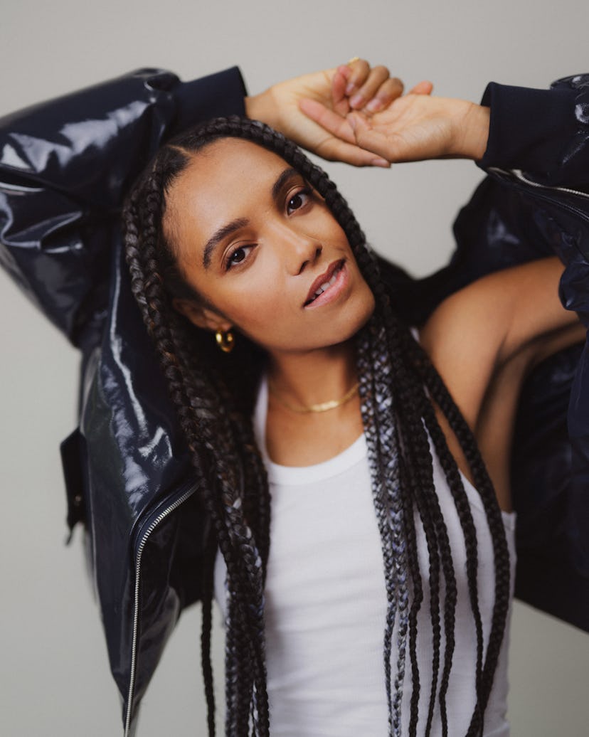 Maisie Richardson posing with her arms up wearing a black jacket
