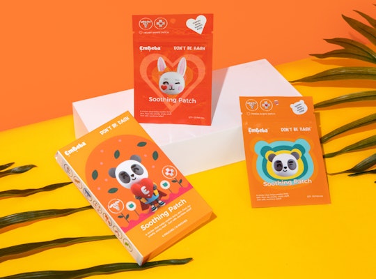 Three packages of EmBeba Soothing Patches for kids on a bright orange and yellow background.
