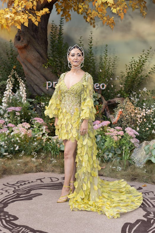 Nazanin Boniadi wearing a yellow gown and headpiece at the world premiere of The Lord Of The Rings: ...