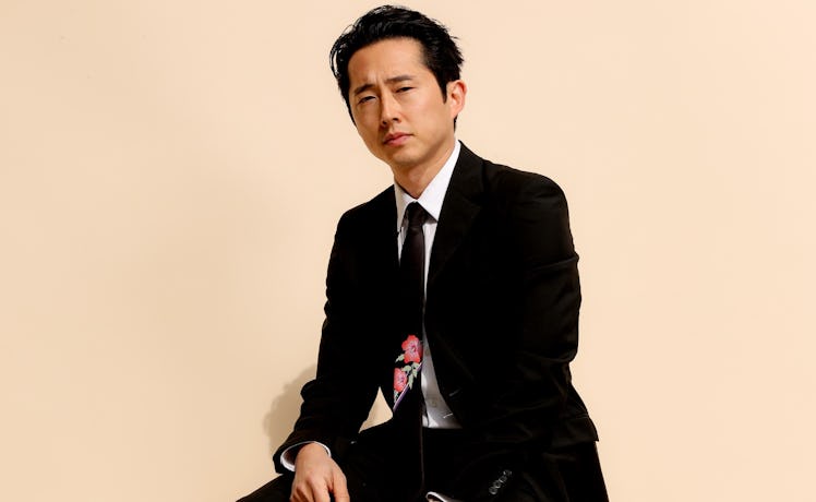 Steven Yeun wearing a floral necktie
