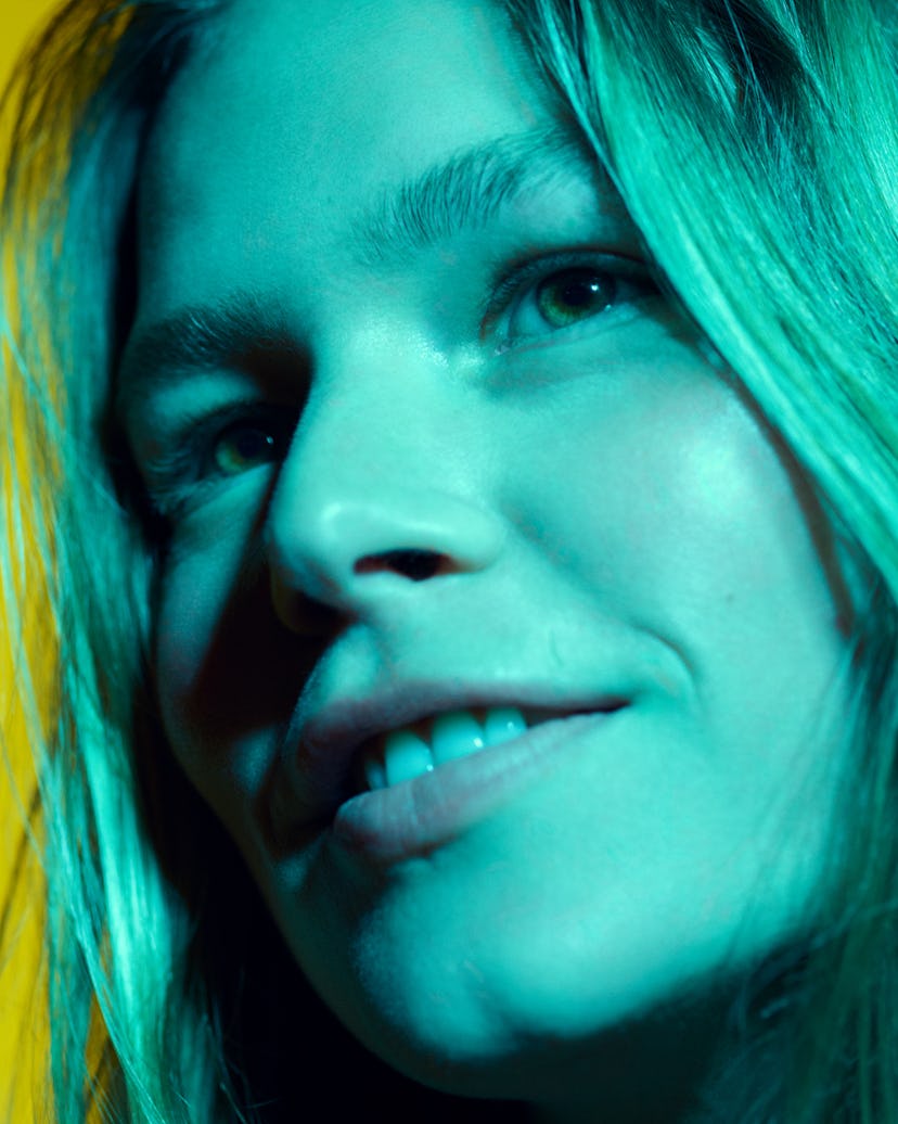 An up close shot of model's face bathed in blue light