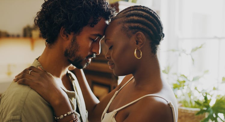 Couple pressing foreheads together in intimate gesture