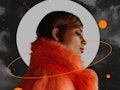 Young woman wearing a furry, orange coat in front of the moon during Uranus retrograde 2022.