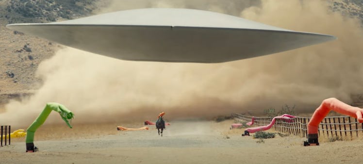 A flying saucer landing in a field in "Nope" movie