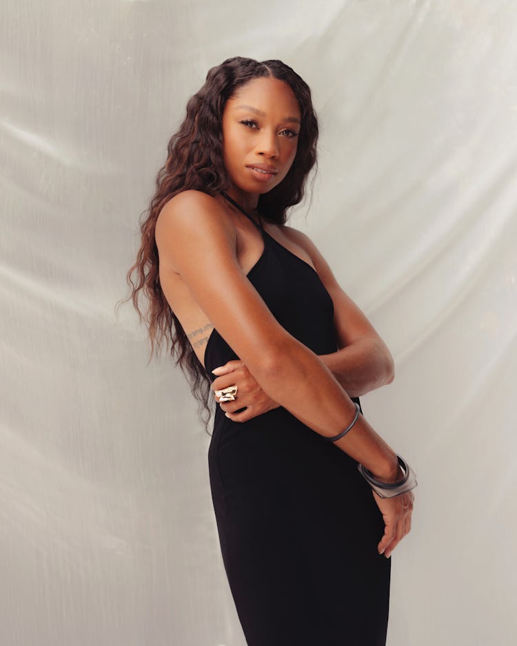 Allyson Felix wearing a black Gucci dress while posing for a photo
