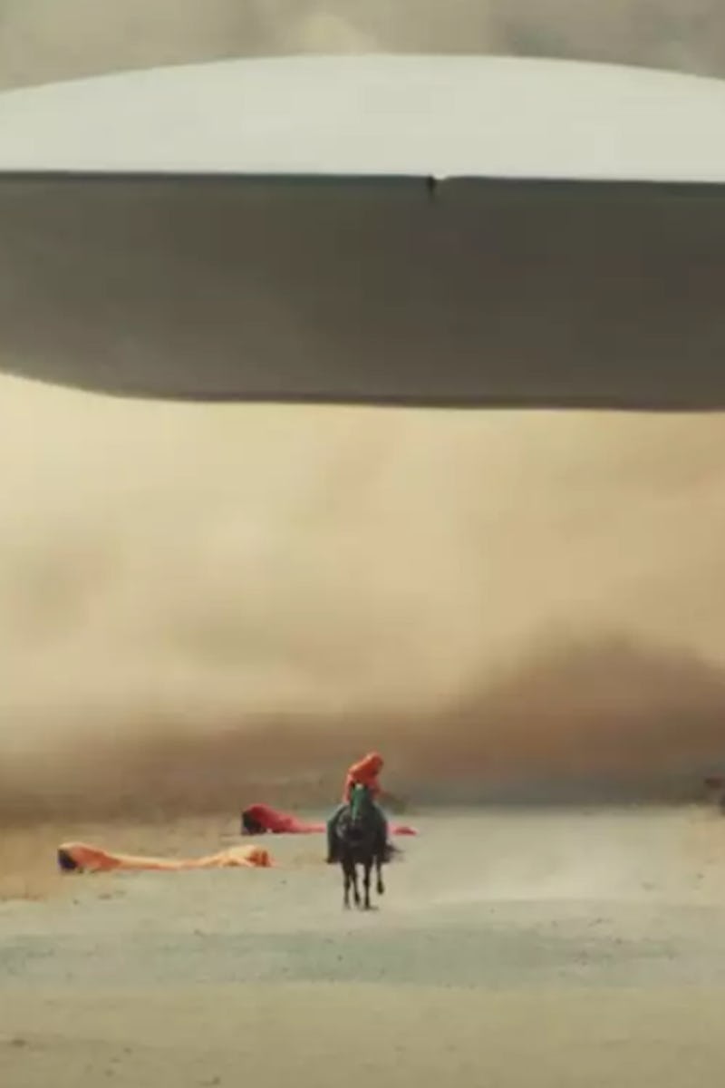 A man riding a black horse in "Nope" movie