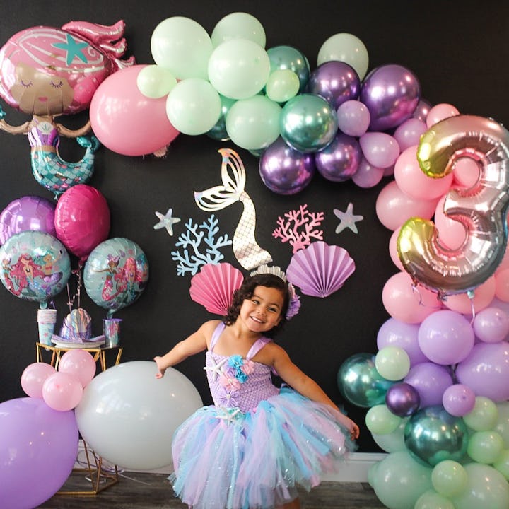 Little girl surrounded with unforgettable decoration for her birthday party