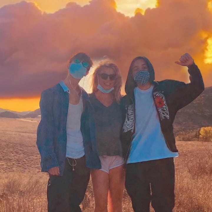 Britney Spears, center, with her two teen sons on each of her sides. She just addressed the comments...