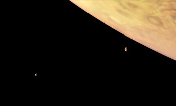 Color image of two moons and a gas planet in space