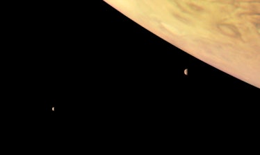 Color image of two moons and a gas planet in space