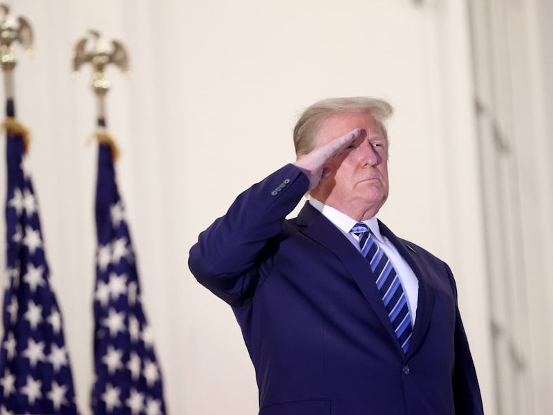 President Donald Trump salutes Marine One helicopter pilots after returning to the White House from ...