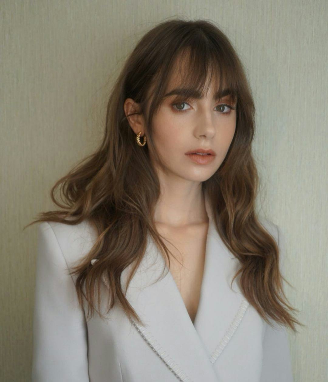 Lily Collins showcases smoked chestnut strands, one of fall 2022&rsquo;s hair color trends to watch.