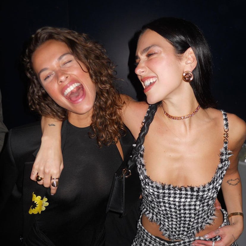dua lipa poses with a friend in a checked corset top