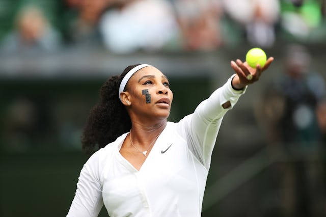 Serena Williams serves during the 2022 Wimbledon women's singles first round match between Serena Wi...