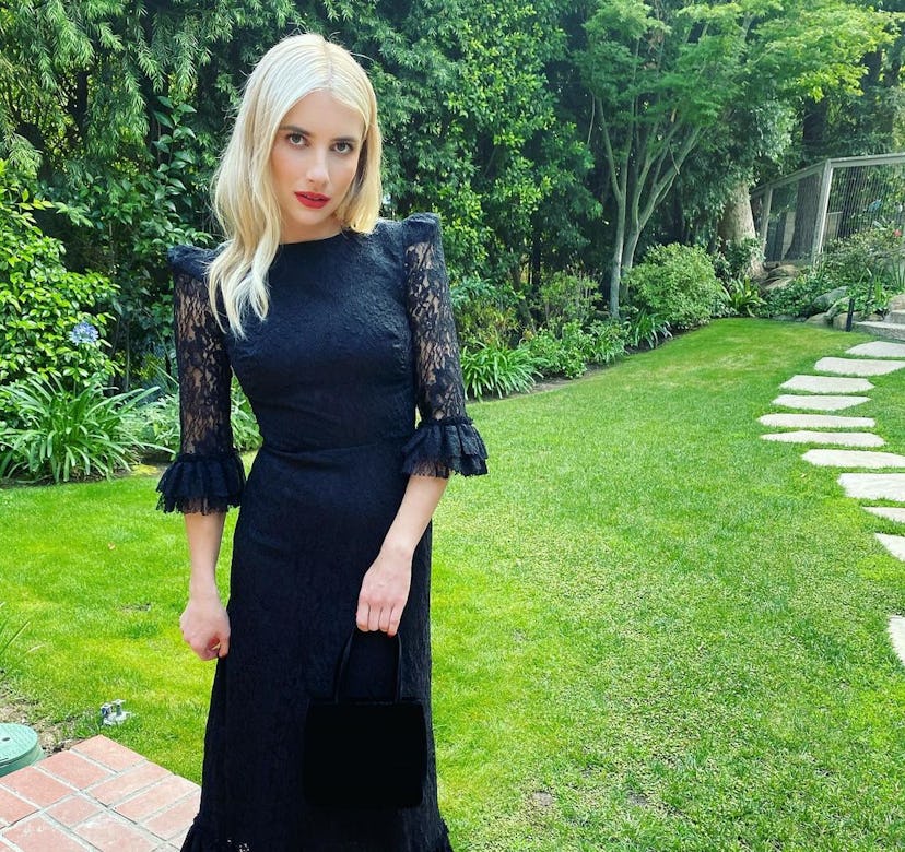 Emma Roberts wears a black dress.