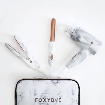 FoxyBae's marble travel kit includes a mini marble curling wand, a mini marble flat iron, and mini m...